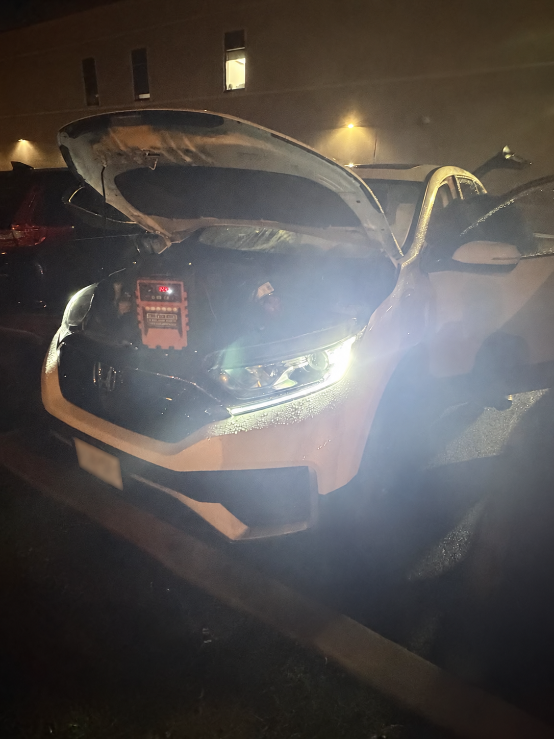Jump pack connected under the hood during a late-night Raritan roadside call.