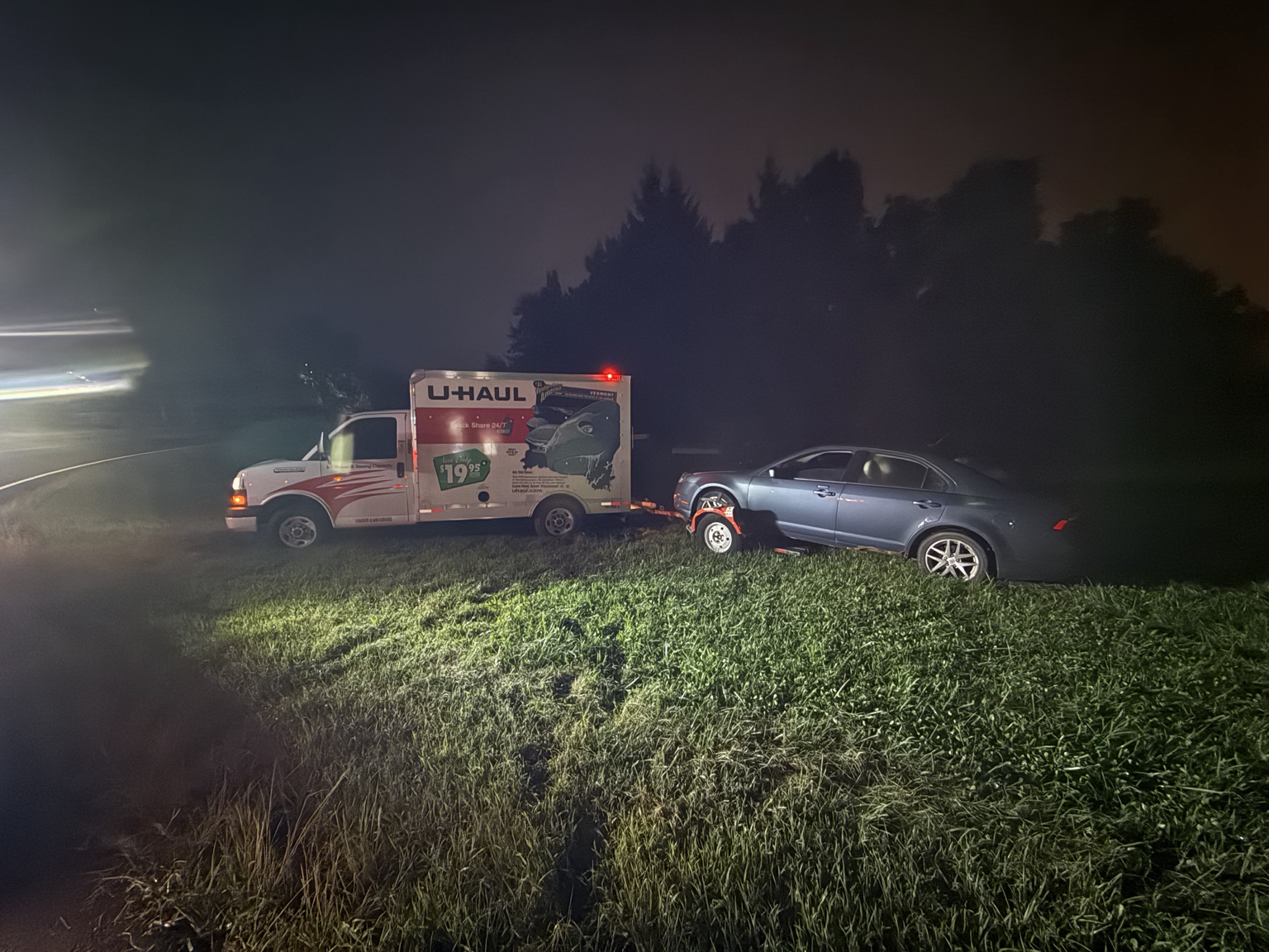 U-Haul truck and vehicle trailer off the roadway during a Green Brook recovery.